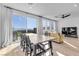 Open-concept living room with plank floors, modern lighting, dining table, and a sliding door to outdoor patio at 5398 Pico Viejo St, Las Vegas, NV 89166