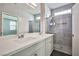 Bathroom featuring double sinks, quartz countertops, modern vanity and tiled glass shower at 5575 Cresent Valley St, Las Vegas, NV 89148