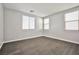 Empty room features wood-look tile floor, white trim, and two windows at 5575 Cresent Valley St, Las Vegas, NV 89148