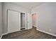 Bedroom with sliding closet doors and wood-look tile flooring at 5575 Cresent Valley St, Las Vegas, NV 89148