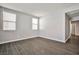 Well-lit bedroom boasts wood-look tile flooring and two windows, creating a comfortable and welcoming atmosphere at 5575 Cresent Valley St, Las Vegas, NV 89148