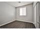 Cozy bedroom with wood-look floors, window with blinds, closet and neutral paint at 5575 Cresent Valley St, Las Vegas, NV 89148