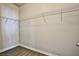 Walk-in closet features metal racks and wood-look tile flooring at 5575 Cresent Valley St, Las Vegas, NV 89148