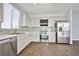 Bright, modern kitchen featuring stainless steel appliances, tile backsplash, and updated countertops at 5575 Cresent Valley St, Las Vegas, NV 89148