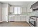 Updated kitchen featuring stainless steel appliances, tile backsplash, and ample counter space at 5575 Cresent Valley St, Las Vegas, NV 89148