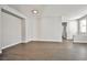 Large living room with wood-look tile flooring, neutral paint, bright lighting, and versatile space at 5575 Cresent Valley St, Las Vegas, NV 89148