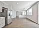 Open-concept living area showcasing recessed lighting and wood-look tile flooring for a modern feel at 5575 Cresent Valley St, Las Vegas, NV 89148