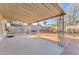 This spacious covered patio in the backyard boasts a blend of concrete and brick paving, perfect for outdoor activities at 5640 Vasila Dr, Las Vegas, NV 89110