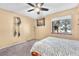 Bedroom with neutral walls, ceiling fan and a bright window offering a glimpse of the outdoors at 5640 Vasila Dr, Las Vegas, NV 89110