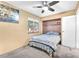 Bedroom with neutral walls, ceiling fan, built in shelves, and a bright window offering a glimpse of the outdoors at 5640 Vasila Dr, Las Vegas, NV 89110