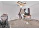 Spacious bedroom with a ceiling fan, carpeted floor, and natural light at 5640 Vasila Dr, Las Vegas, NV 89110