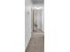 Hallway with neutral carpet and paint leads to the bedrooms and bathrooms at 5640 Vasila Dr, Las Vegas, NV 89110