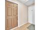 Neutral-colored hallway featuring a paneled door, a white door, and a gray entry mat at 5640 Vasila Dr, Las Vegas, NV 89110