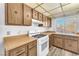 Functional kitchen featuring wood cabinetry, laminate countertops, and ample natural light at 5640 Vasila Dr, Las Vegas, NV 89110