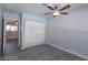 Clean bedroom with a ceiling fan, light gray flooring, and a bi-fold door closet at 5816 W Cherokee Ave, Las Vegas, NV 89103