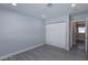 Cozy bedroom with light gray flooring, walls, and a bi-fold door closet at 5816 W Cherokee Ave, Las Vegas, NV 89103