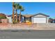 Single-story home with a 2-car garage, desert landscaping, and a brick border at 5816 W Cherokee Ave, Las Vegas, NV 89103