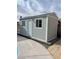 Pool shed on concrete foundation with two windows, a door, and an outdoor light at 5816 W Cherokee Ave, Las Vegas, NV 89103