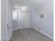 Clean shed interior featuring gray vinyl flooring, closet, and an air conditioning unit at 5816 W Cherokee Ave, Las Vegas, NV 89103