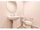 Bathroom featuring a pedestal sink and toilet against a neutral backdrop, offering functionality in a compact space at 639 Grey Saker St, Las Vegas, NV 89138