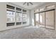 Sunlit bedroom with carpet, multiple windows, and sliding glass door leading to a balcony at 639 Grey Saker St, Las Vegas, NV 89138