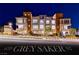 Modern three-story condo with large windows and stylish exterior lighting at twilight at 639 Grey Saker St, Las Vegas, NV 89138