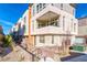 Modern three-story home with a balcony, stone facade, and contemporary landscaping at 639 Grey Saker St, Las Vegas, NV 89138