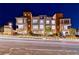 Cordillera community townhome showcasing three-story facade with well-lit windows at dusk at 639 Grey Saker St, Las Vegas, NV 89138