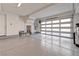 A garage that features epoxy floors, bright lighting, and a translucent garage door, creating a functional and inviting space at 639 Grey Saker St, Las Vegas, NV 89138