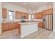 Open kitchen design with a center island, stainless steel refrigerator, and stylish lighting at 639 Grey Saker St, Las Vegas, NV 89138