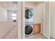 Convenient stacked washer and dryer unit with a countertop and cabinets, nestled in a well-lit, accessible laundry area at 639 Grey Saker St, Las Vegas, NV 89138