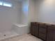 Unfinished bathroom with a shower stall, dark wood cabinets and a small window at 6616 Bowery St, Las Vegas, NV 89148
