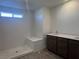 Bathroom with dual sinks, white countertops, and a walk-in shower at 6616 Bowery St, Las Vegas, NV 89148