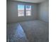 Bright bedroom with neutral carpet and natural lighting at 6616 Bowery St, Las Vegas, NV 89148
