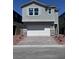 Beautiful two-story home featuring stone accents, a spacious two-car garage, and manicured landscaping at 6616 Bowery St, Las Vegas, NV 89148