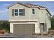 Two-story home featuring a neutral color scheme, tan shutters, and a two-car garage at 6616 Bowery St, Las Vegas, NV 89148