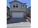 Two-story home features a gray exterior, a two-car garage, and a brick driveway at 6616 Bowery St, Las Vegas, NV 89148