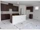 Spacious kitchen with dark wood cabinets, a white island, and plenty of counter space at 6616 Bowery St, Las Vegas, NV 89148