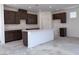 Unfinished kitchen with dark wood cabinetry, a center island and white countertops at 6616 Bowery St, Las Vegas, NV 89148