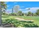 Beautiful golf course featuring lush green fairways, a sand trap, and city views at 668 Oakmont Ave # 1724, Las Vegas, NV 89109