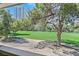 Expansive golf course view with lush green grass, trees, and a backdrop of modern buildings at 668 Oakmont Ave # 1724, Las Vegas, NV 89109