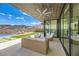 Relaxing outdoor space featuring a covered patio with wicker furniture and breathtaking mountain views at 678 Blackrock Rim Dr, Henderson, NV 89012