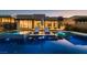 Stunning backyard pool reflecting the house, featuring lounge chairs, a spa, and ample space for recreation at 678 Blackrock Rim Dr, Henderson, NV 89012