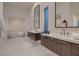 Bright bathroom featuring dual vanities, soaking tub, and modern fixtures at 678 Blackrock Rim Dr, Henderson, NV 89012