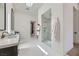 Modern bathroom with glass-enclosed shower, double sinks, and stylish white tile at 678 Blackrock Rim Dr, Henderson, NV 89012