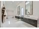 Contemporary bathroom boasting dual vanities, a soaking tub, and ample natural light at 678 Blackrock Rim Dr, Henderson, NV 89012