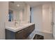 Modern bathroom featuring double sinks, sleek cabinetry, a large mirror, and a glass-enclosed shower with stylish fixtures at 678 Blackrock Rim Dr, Henderson, NV 89012