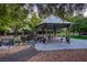 Charming community gazebo with picnic tables, surrounded by lush greenery and benches, providing a relaxing gathering space at 678 Blackrock Rim Dr, Henderson, NV 89012