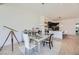 Open-concept dining area with a modern chandelier and views of kitchen and backyard at 678 Blackrock Rim Dr, Henderson, NV 89012