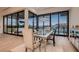 Modern dining room with chandelier, floor to ceiling windows and stunning views at 678 Blackrock Rim Dr, Henderson, NV 89012